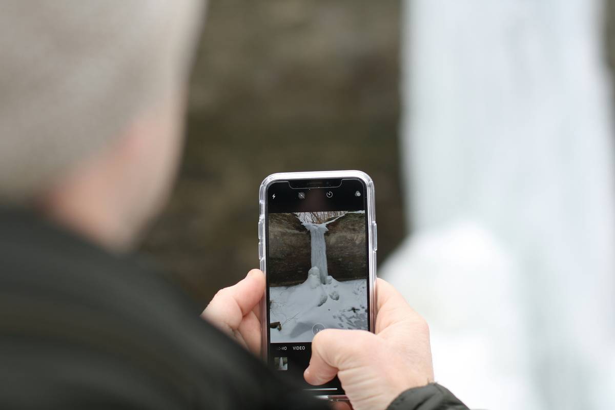 Image showing a person using auto sync subtitles app on their phone