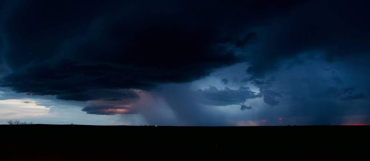 A mesocyclone over Texas glows from lightning with a downburst of rain.