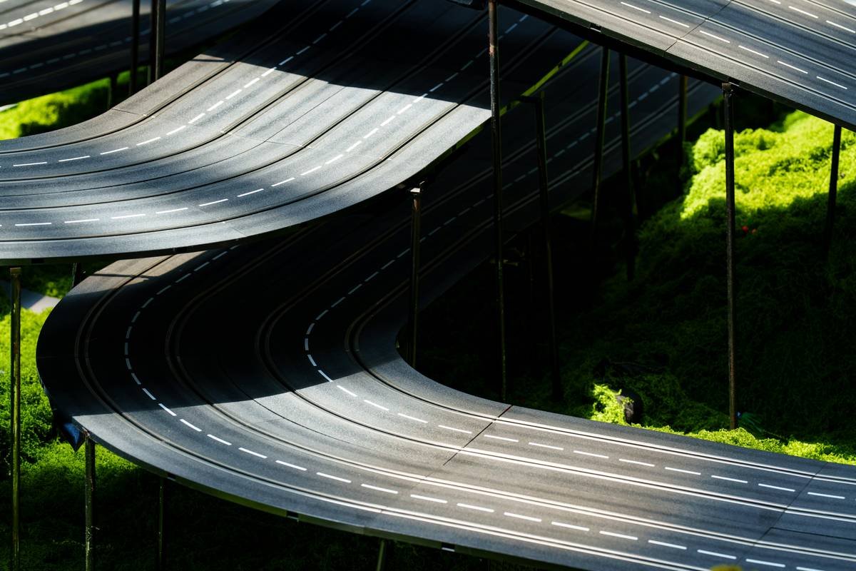 Curving roads weave through green grass.